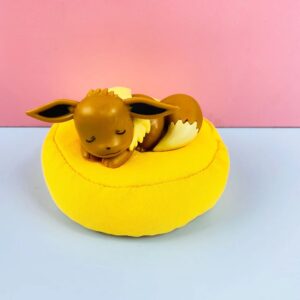 Sleeping Eevee Figure on Yellow Plush Cushion – Dreaming Pokémon Collectible
